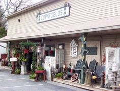 the front of a store with lots of furniture and decorations on it's display