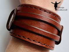 Leather Handmade Bracelet A handcrafted men's bracelet is an elegant addition to daily outfits. High-quality leather ensures durability and elegant appearance, and the handmade craftsmanship guarantees the uniqueness of each bracelet. Made of natural leather, the bracelet has two straps, which through the arrangement on the main wider strap, with a width of 4.5 cm, makes the product more three-dimensional. With three clasps at a length of 17 cm to 20 cm, the bracelet is flexible and easily adapts to each hand. It is perfect as a gift for a man or as a decoration for yourself. Adjustable Leather Cuff Bracelet With Waxed Finish, Leather Bracelet With Wrist Strap For Everyday Use, Adjustable Leather Cuff Bracelet With Bracelet Strap, Leather Wristband For Everyday Use, Everyday Leather Wristband With Bracelet Strap, Modern Brown Leather Bracelet With Wrist Strap, Brown Leather Cuff Bracelet For Everyday, Everyday Brown Leather Cuff Bracelet, Adjustable Leather Wristband With Waxed Finish