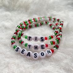 "Festive Christmas bracelet set. Made with red, white, and green glass beads and white plastic alphabet letters that spell out \"TIS THE SEASON\". Set includes 3 bracelets, with each bracelet bearing one word. Makes a super cute stocking stuffer!" White Letter Beads Bracelets For Holidays, White Letter Beads Jewelry For Christmas, White Christmas Jewelry With Letter Beads, Personalized White Christmas Bracelet, White Beaded Bracelets With Letter Beads For Christmas, Cute Stocking, Christmas Message, Friendship Bracelets With Beads, Girls Holiday