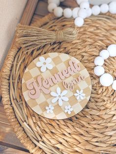 a close up of a basket with flowers and beads on the table next to it