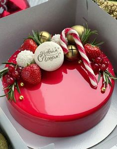 a heart shaped cake decorated with strawberries and candy canes