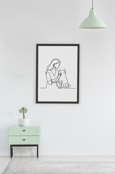 a black and white drawing of a woman holding a cat in her lap next to a green dresser