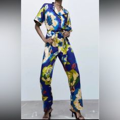 Experience A Vibrant And Colorful Summer With This Zara Nwt Woman Floral Print Jumpsuit In Size S. Perfect For Any Occasion, This One-Piece Garment Features A Collared Neckline And Long Sleeves With A Straight Leg Style. The Jumpsuit Is Made Of 100% Polyester, Making It Machine Washable And Easy To Care For. With A Beautiful Floral Pattern And Colorful Theme, This Jumpsuit Is Great For Travel, Parties, Workwear, Or Casual Outings. The Brand Zara Is Known For Its Regular Fit And High-Quality Fabr Elegant Blue Floral Print Sets, Elegant Blue Sets With Floral Print, Elegant Blue Set With Floral Print, Chic Short Sleeve Sets With Floral Print, Chic Short Sleeve Floral Print Set, Blue Pants From Matching Set, Blue Pants Matching Set, Blue Printed Party Set, Blue Matching Set Bottoms For Summer