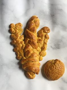 a croissant and an orange on a marble surface