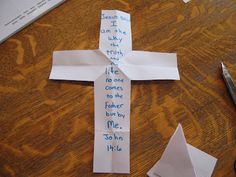 a cross made out of paper with writing on it