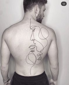 the back of a man with a tattoo on his neck and shoulder is shown in black ink