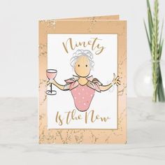 a card with an image of a woman holding a wine glass and the words seventy is the new