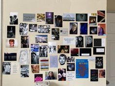 a refrigerator covered in pictures and magnets next to a white wall with a door