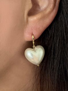 Large Heart acrylic Pearl Earrings, Heart dangling earrings, Bridal Jewelry, Gift for her, Imitation Pearl, Gold Huggies, Heart earrings This Cute Puffy imitation(fake/acrylic) pearl dangling from a small gold hoop earrings is very charming. Great piece for a wedding party or daily wear. * Total Heart pearl Hoop drop earrings measures approx. 30mm * Imitation Acrylic Heart Pearl measures approx. 17.2mm x 19mm and 11.5mm Thick ** Matching Earrings ** https://www.etsy.com/listing/1521279859/large-heart-acrylic-pearl-necklace-gold?click_key=fac6d962d950cf3f37620a1fb31158dd2cefefdb%3A1521279859&click_sum=083acbe9&ref=shop_home_active_7 ---------------------------------------------------------------------- ** F E A T U R E S ** - Imitation Acrylic Heart Pearl - Gold Brass Hoop earrings -------- Heart-shaped Pearl Party Earrings, Heart-shaped Pearl Earrings For Valentine's Day, White Heart-shaped Pearl Earrings For Party, White Heart-shaped Pearl Earrings For Valentine's Day, Valentine's Day Pearl Drop Earrings For Party, Single Heart Earring For Wedding, Valentine's Day Party Pearl Drop Earrings, Valentine's Day Dangle Pearl Earrings For Pierced Ears, White Heart Charm Earrings For Party