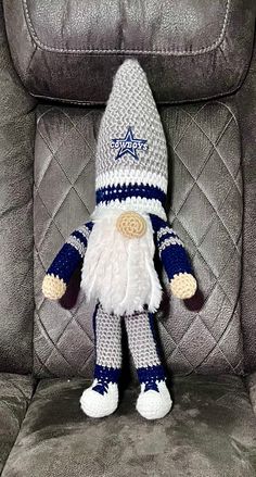 a crocheted gnome sitting in a chair