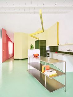 an empty kitchen with green and yellow walls