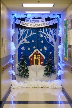 A decorated classroom door featuring a "Winter Wonderland" theme with a snowy backdrop, a house in the center, glittering trees, snowflakes, and cotton snow accents creating a festive and cozy holiday vibe. Cute Christmas Door Decorating Contest, Holiday Door Decorating Contest Work, Winter Door Decorations For Work, Let It Snow Door Decoration, Christmas Door Decorating Contest High School, Christmas Door Decorations For School Contest Winter Wonderland, Winter Wonderland Door Decorations For School, Christmas Decor Ideas For Classroom Door, Christmas Decor Preschool