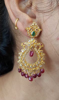 22 karat gold uncut diamond 'peacock' drop earrings with rubies, emeralds & beads  

this is a final sale. no return or exchange will be possible on this item 

introducing our exquisite 22 karat gold uncut diamond 'peacock' drop earrings, a true masterpiece crafted in india by totaram jewelers. this stunning piece of jewelry is adorned with beautiful rubies, emeralds, and beads, making it a perfect accessory for any occasion.
  
  made with the finest quality uncut diamonds, also known as polki Festive Temple Jewelry Earrings With Round Beads, 22k Gold Peacock Chandbali Earrings, Kundan Temple Jewelry Earrings With Round Beads, 22k Gold Peacock Design Earrings For Festivals, Kundan Round Beads Temple Jewelry Earrings, 22k Gold Earrings With Peacock Design For Festivals, Festive Bollywood Style Earrings With Round Beads, Bollywood Style Round Bead Earrings For Festive Occasions, Festive Stone Work Beaded Earrings