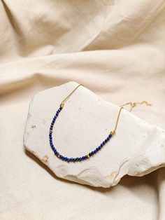 This natural lapis lazuli necklace with fine gold plated layering chain is created with small, high quality, shiny, blue lapis lazuli gemstone beads and a fully adjustable gold plated chain. In addition, our dainty lapis choker is perfect as a gift for mom, for your sister or for whoever you cherish the most.  Don't forget that you have the opportunity to combine this lapis lazuli necklace with its matching hoop earrings! They look spectacular as a blue jewelry set. You can select the complete set or just the necklace, your choice. The matching earrings are 2.5 cm (1 inch) gold plated hoops with the same lapis lazuli beads as the necklace: https://www.etsy.com/us-es/listing/1554281338/pendientes-de-aro-de-oro-lapislazuli?ref=listings_manager_grid ** D E T A I L S ** Gemstones size we use a Royal Blue Lapis Lazuli Necklaces With Round Beads, Royal Blue Lapis Lazuli Necklace With Round Beads, Adjustable Lapis Lazuli Crystal Necklace, Yellow Gold Lapis Lazuli Minimalist Jewelry, Minimalist Yellow Gold Lapis Lazuli Jewelry, Royal Blue Round Beads Necklace For Gift, Lapis Lazuli Gemstone Beads Necklace For Gift, Lapis Lazuli Round Beads Necklace For Gift, Sapphire Gemstone Beads Necklace In Lapis Lazuli