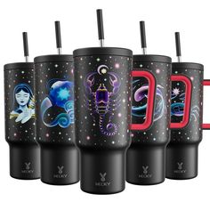 four travel mugs with different designs and colors on the same cup, one has a straw in it