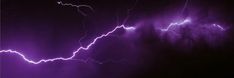 purple lightning strikes in the night sky