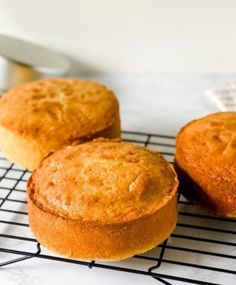 three muffins sitting on top of a cooling rack