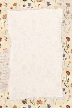 an old piece of paper with flowers and writing on the bottom left corner, in front of a floral background