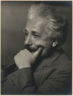 an old black and white photo of a man with his chin resting on his hand