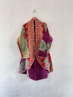 Handmade vintage cotton Kantha Jacket by artisans from the nomadic desert tribe known as "Banjara ", in the Northern India. This jacket is reversible pattern you can use both side and all side contains vibrant colors  This jacket is made from the vintage old cotton fabric and have kantha work b y hand this may contains small patches but that not affect the beauty of this jacket  The Jacket is no closure pattern with Long Sleeves and Vibrant Color  Size Measurements :  Chest 44 inch  Length front 34 inch  Back Length 44 inch  sleeve 25 inch Coat Fits S to XL Size  Shipping : Free worldwide shipping. (Note : These Jackets are made with vintage kantha quilts, THESE VINTAGE KANTHA QUILTS HAVE SOME STAINS AND OLD FABRIC HAS MISSING THREADS so there may be some imperfections. That thing make the Nomadic Desert, Coat Fits, Kantha Jacket, Kantha Quilts, Kantha Work, Vintage Kantha Quilts, Reversible Jacket, Vintage Kantha, Kantha Quilt