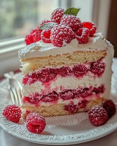 a piece of cake with raspberries on top