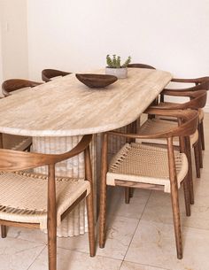 a dining table with chairs around it and a bowl on top of one of the tables