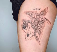 a woman's thigh with an angel tattoo on her left leg and the words techno written in black ink