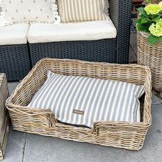 two wicker baskets with pillows on the ground