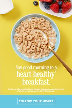 a bowl of cereal with strawberries and blueberries on the side next to it