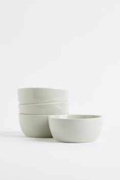 three white bowls sitting on top of each other