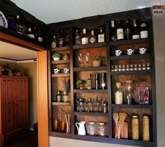 the shelves in the kitchen are filled with spices