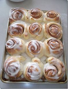 a pan filled with cinnamon rolls sitting on top of a counter next to an instagram page