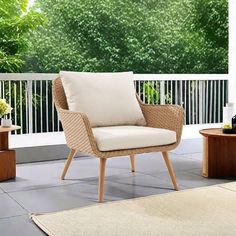 a chair and table on a porch with trees in the background