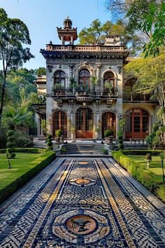 an elaborately designed walkway leads to the front entrance of a large, ornate home