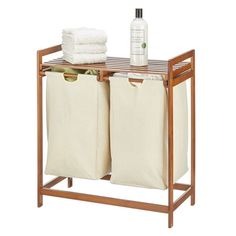 two white bags are sitting next to each other on a wooden rack with towels and bottles