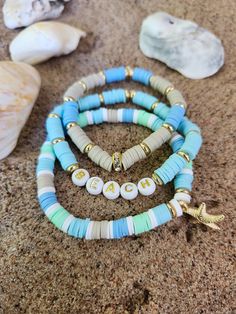 Dive into Summer with this beach inspired Heishi Bead Bracelet! Make a splash with this adorable heishi bead bracelet set that captures the magic of the sea!  These bracelets features a beautiful array of colors inspired by the ocean and a  sparkly starfish charm! Product features: Handcrafted with high-quality heishi beads in ocean blues, seafoam green, and sand colors. Strong, stretchy cord for a comfortable fit on most wrists. Lightweight and water-resistant - perfect for summer wear! Makes a great gift for yourself or any beach or ocean lover! Add a touch of ocean magic to your wrist and show off your love for the sea with this unique bracelet! Ocean-inspired Beaded Bracelets For Beach, Adjustable Beachy Beaded Bracelets With Letter Beads, Beachy Adjustable Beaded Bracelets With Letter Beads, Letter Beads Beaded Bracelet For Beach Vacation, Bohemian Jewelry With Letter Beads For Beach Season, Beachy Bracelet With Colorful Beads On Strand, Colorful Heishi Beads Beach Jewelry, Beachy Bracelets With Colorful Beads, Beachy Beaded Bracelets For Beach Season Vacation