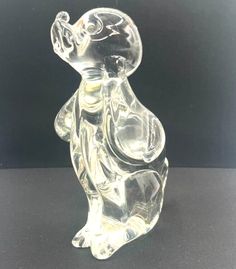 a clear glass bear sitting on its hind legs