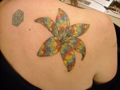 a woman with a colorful flower tattoo on her back