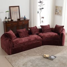 a living room with a sectional couch and coffee table on the floor next to it