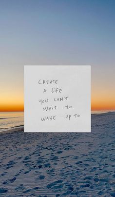 a sign on the beach that says create a life you can't want to wake up