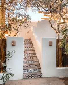 an outdoor staircase with tiled steps leading up to the house