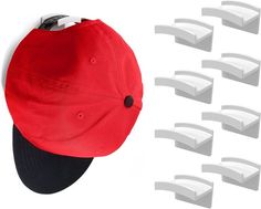 a red hat with black brimmed peak and eight white curved brimmed caps