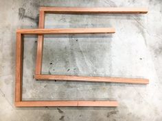 two wooden frames sitting on top of a cement floor