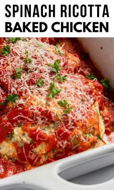 spinach ricotta baked chicken in a white casserole dish