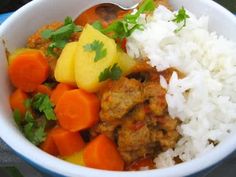 a white bowl filled with rice, meat and veggies