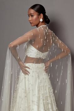 Ivory lehenga featuring embroidered 3-D bellflower motifs in jaal pattern, highlighted by pearls and crystals. Comes with matching embroidered strapless blouse and embellished trail dupatta. - Aza Fashions White Choli With Pearl Embroidery For Wedding, White Wedding Choli With Pearl Embroidery, White Organza Choli With Pearl Embroidery, Off White Embellished Lehenga For Wedding, Fitted Organza Wedding Dress With Sheer Dupatta, Ceremonial Choli With Floral Embroidery In Traditional Drape, White Choli With Sheer Dupatta For Wedding, White Embellished Organza Dupatta, Fitted White Wedding Dress With Dupatta