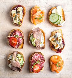 an assortment of sandwiches with different toppings on them