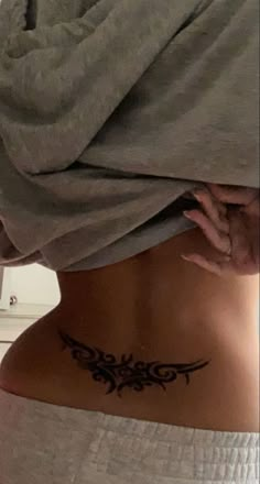 a woman with a tattoo on her back