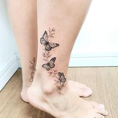 a woman's legs with butterfly tattoos on them