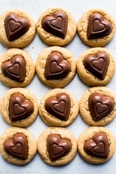 cookies with chocolate hearts arranged on a baking sheet